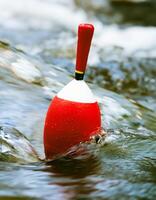 Red Bobber Floating in a Stream photo