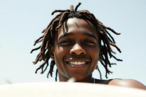 Close-up Portrait of a Smiling Man with Dreadlocks photo