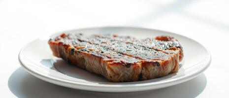 Grilled Pork Chop on a White Plate photo