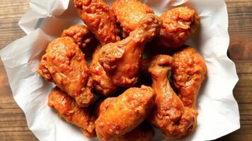 Close Up of Crispy Chicken Wings in a Paper Basket photo