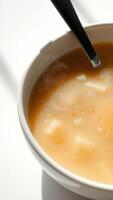 Close-Up of a Bowl of Soup with a Spoon photo