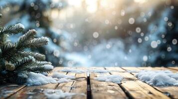 Snow-covered wooden table with a pine tree branch in the foreground and a snowy forest in the background photo