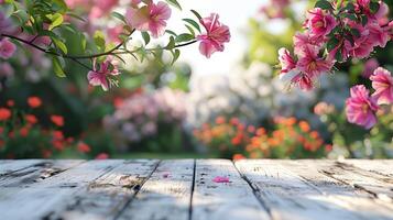 Serene and inviting atmosphere created by pink flowers hanging over an empty wooden table in a garden photo