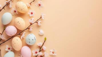 Top view flat lay photo of easter decorations painted pastel eggs, spring blossom on beige background with copy space.