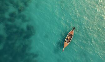 Boat on the water surface from top view, turquoise blue water background from top view, summer seascape from air, island, travel and vacation image photo