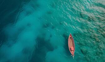 Boat on the water surface from top view, turquoise blue water background from top view, summer seascape from air, island, travel and vacation image photo