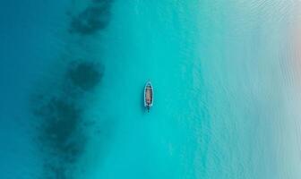 Boat on the water surface from top view, turquoise blue water background from top view, summer seascape from air, island, travel and vacation image photo