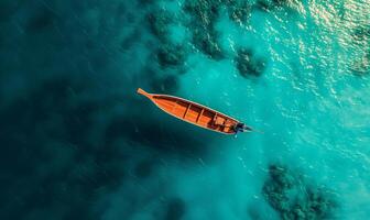 Boat on the water surface from top view, turquoise blue water background from top view, summer seascape from air, island, travel and vacation image photo