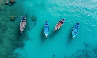 Boats on the water surface from top view, turquoise blue water background from top view, summer seascape from air, island, travel and vacation image photo