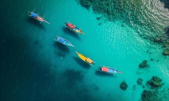 Boats on the water surface from top view, turquoise blue water background from top view, summer seascape from air, island, travel and vacation image photo