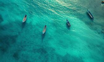 Boats on the water surface from top view, turquoise blue water background from top view, summer seascape from air, island, travel and vacation image photo