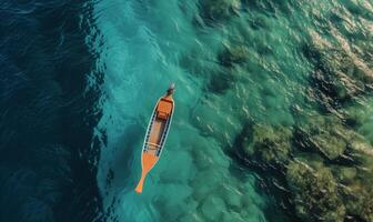 Boat on the water surface from top view, turquoise blue water background from top view, summer seascape from air, island, travel and vacation image photo