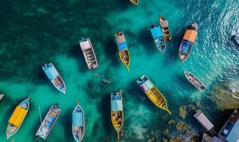 Boats on the water surface from top view, turquoise blue water background from top view, summer seascape from air, island, travel and vacation image photo