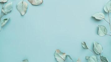 Minimal floral frame of silver eucalyptus leaves on a soft blue background photo