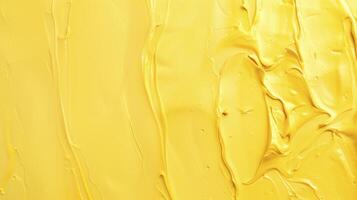 Abstract textured background created by flowing and mixing yellow acrylic paint photo