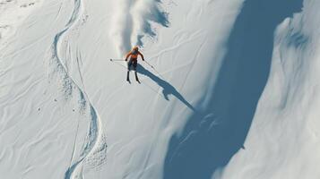 Skier creates fresh tracks on the snowy mountain slopes under the bright sun photo