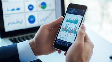 Businessman in the office using a digital tablet to review financial charts photo
