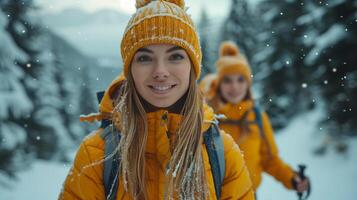 Two women hikers happily traverse a snowy trail on a beautiful winter day photo