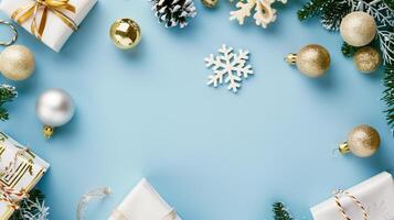 Framed christmas decorations on a pastel blue background with space for text photo