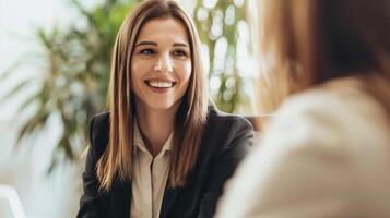 Smiling businesswoman in a bright office during a meeting with a colleague photo