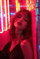 Brunette model with red lipstick and a silver necklace is posing under red neon lights for a photoshoot photo