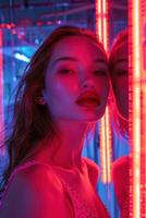 Fashion model with bright makeup posing near neon lights with reflection in mirror photo