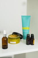 Close up of body care cosmetic products on shelf in cosmetology. Spa and piling cosmetics photo