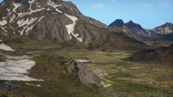 A mountain range with snow on the top of it video