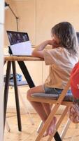 vertical Young girl attending online class using laptop at home video