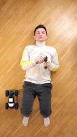 vertical man lying on his back controls toy rc car with a remote control video