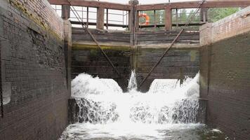 Water rushing through open lock gates on canal video