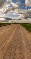 vertical little planet transformation with curvature of space among fields in blue sky with clouds video