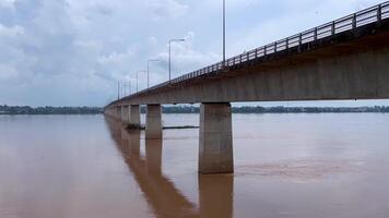 A scenic bridge crossing over a flowing river, capturing the tranquil movement of the water beneath. The bridge, architecture, infrastructure, and serene landscapes, Ideal for themes related to travel video
