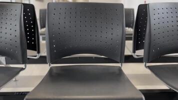 rows of airport chairs in a modern terminal, clean, sleek design of seating arrangements often seen in airports, providing a calm and organized environment, travel, transportation, airport design video