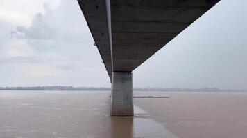 A scenic bridge crossing over a flowing river, capturing the tranquil movement of the water beneath. The bridge, architecture, infrastructure, and serene landscapes, Ideal for themes related to travel video