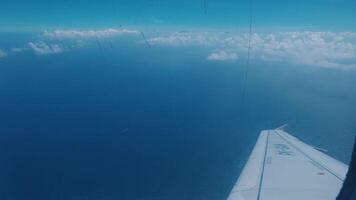 Aerial View of Ocean and Clouds from Airplane Window video