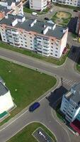 New residental building appartments in modern complex near the green fields in summer. Beautiful flying over the city in a new district. Aerial view Vertical video