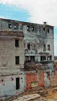 Abandoned building. Aerial view of an old factory ruin and broken windows. Vertical video