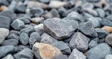 Collection of smooth river stones in various shades on a natural surface photo