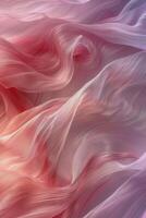 Flowing sheer fabric in shades of pink and lavender illuminated by soft light photo