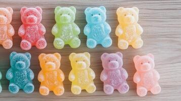 Colorful gummy bears lined up on a wooden surface in soft natural light photo