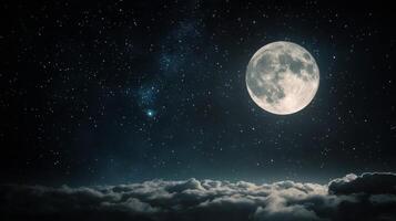 Full moon glowing over clouds with a starry night sky photo