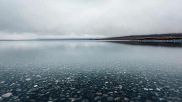 Calm lake reflecting cloudy skies in a tranquil natural setting photo