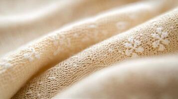 Intricate floral pattern on fabric with gold highlights and soft textures photo