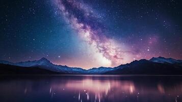Starry night sky over calm lake surrounded by mountain ranges at twilight photo