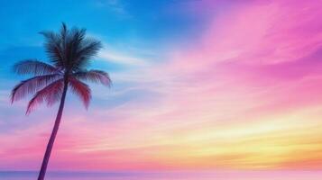 Beautiful sunset over the ocean with a single palm tree on the sandy beach photo