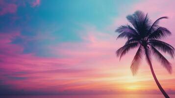 Beautiful sunset over the ocean with a single palm tree on the sandy beach photo