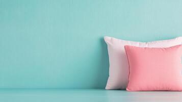 Soft cushions arranged on a turquoise wall backdrop in a bright interior setting photo