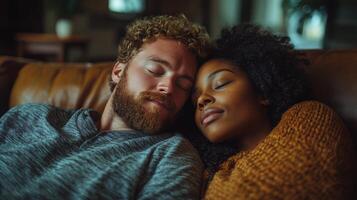 Cozy couple relaxing together on a couch in a warm, intimate setting during the evening photo