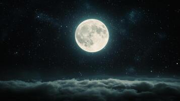 Full moon glowing over clouds with a starry night sky photo